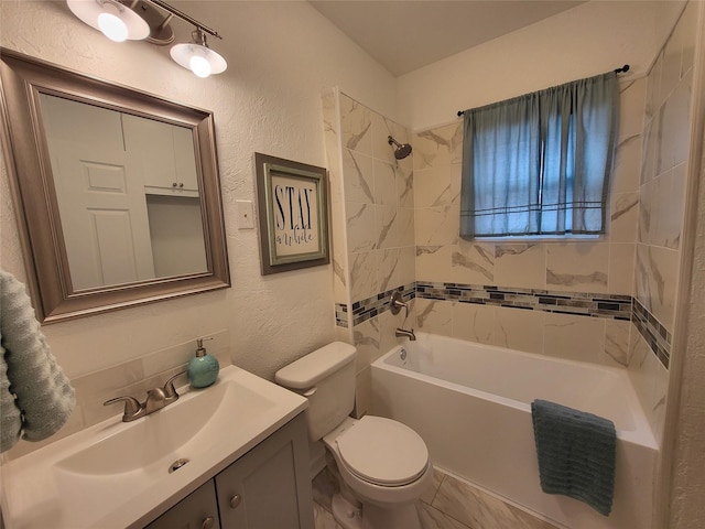 full bathroom with vanity, tiled shower / bath combo, and toilet