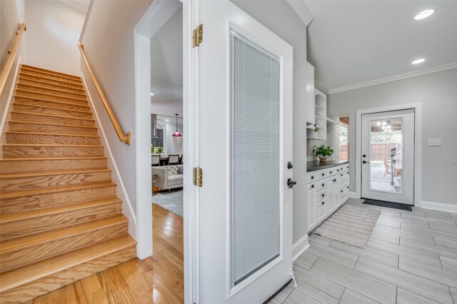 laundry room with cabinets, independent washer and dryer, ornamental molding, and sink