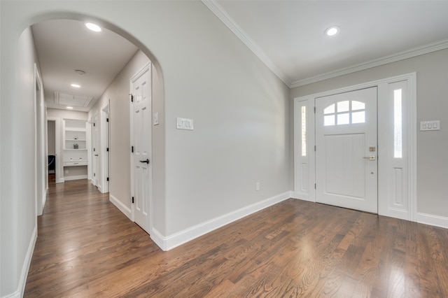 foyer entrance featuring crown molding and dark hardwood / wood-style flooring