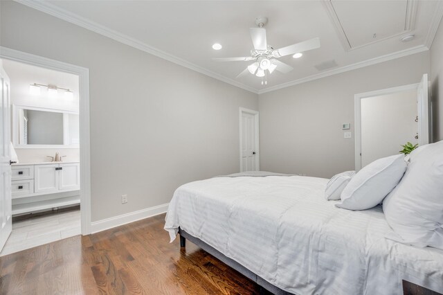 bedroom featuring ceiling fan, dark wood-type flooring, and ensuite bath