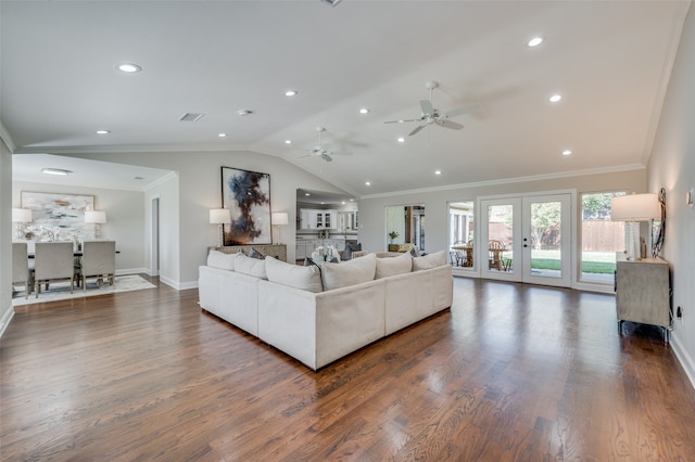 living room featuring french doors, ornamental molding, ceiling fan, dark wood-type flooring, and lofted ceiling