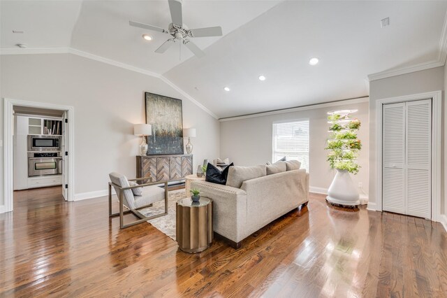 living room with hardwood / wood-style flooring, crown molding, ceiling fan, and lofted ceiling