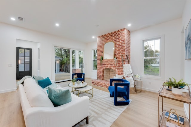 living room with a fireplace and light hardwood / wood-style flooring