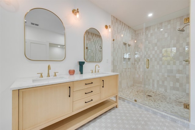 bathroom featuring a shower with shower door and vanity