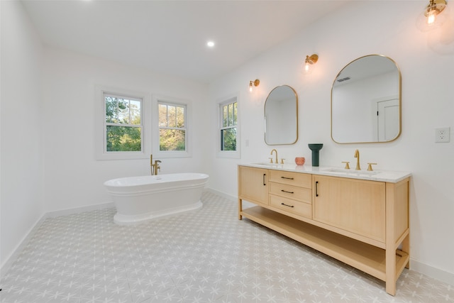 bathroom with a washtub and vanity