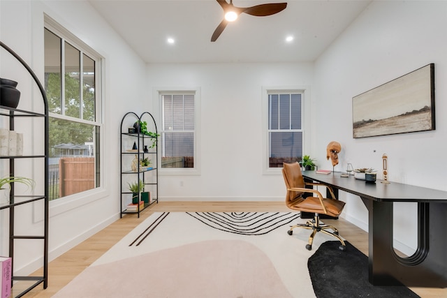 home office featuring light hardwood / wood-style floors and ceiling fan