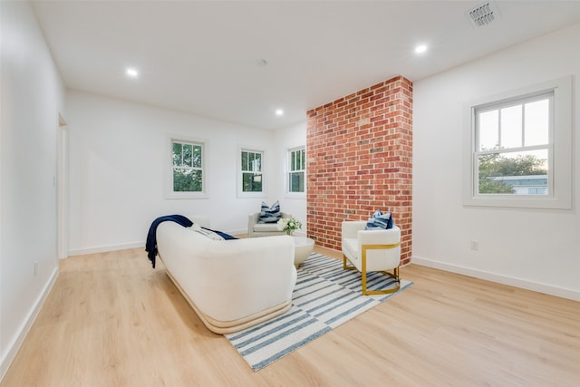 living room featuring light wood-type flooring and a wealth of natural light