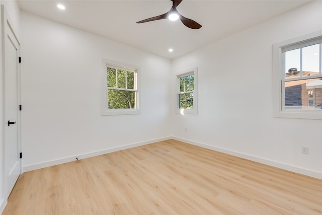 spare room featuring ceiling fan and light hardwood / wood-style floors