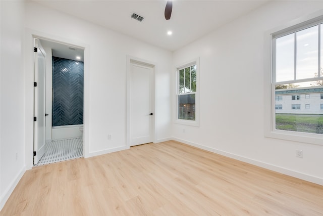 unfurnished bedroom featuring light wood-type flooring and ceiling fan