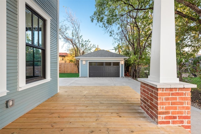 wooden deck featuring an outbuilding and a garage