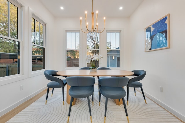 dining room with an inviting chandelier and light hardwood / wood-style floors