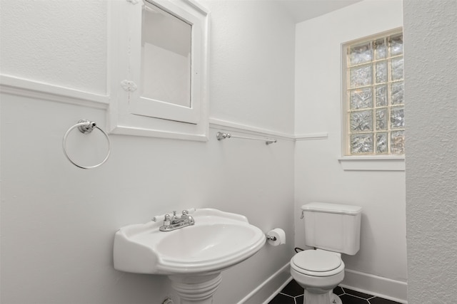 bathroom featuring tile patterned flooring, toilet, and sink