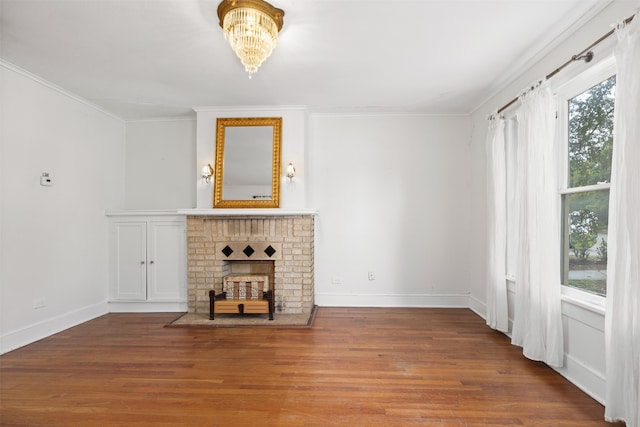 unfurnished living room with hardwood / wood-style flooring, plenty of natural light, and crown molding