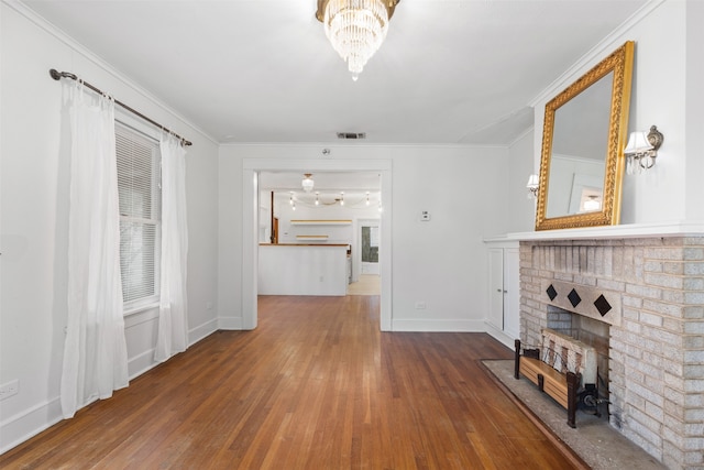 living room with a fireplace, hardwood / wood-style flooring, and crown molding