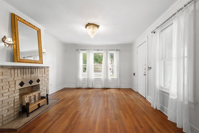 living room featuring ornamental molding, hardwood / wood-style floors, and a fireplace