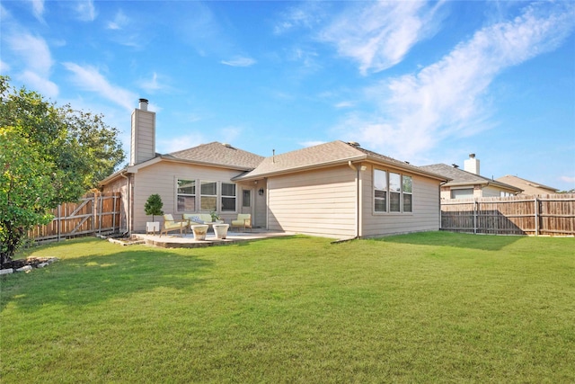 rear view of property featuring a lawn and a patio