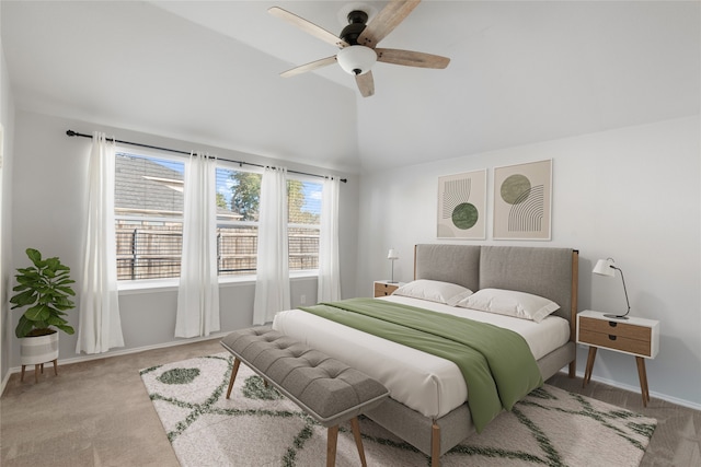 bedroom with ceiling fan, lofted ceiling, and light carpet