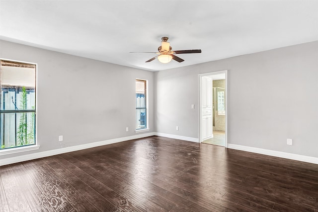 spare room with dark wood-type flooring and ceiling fan