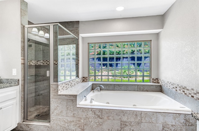 bathroom with independent shower and bath and vanity