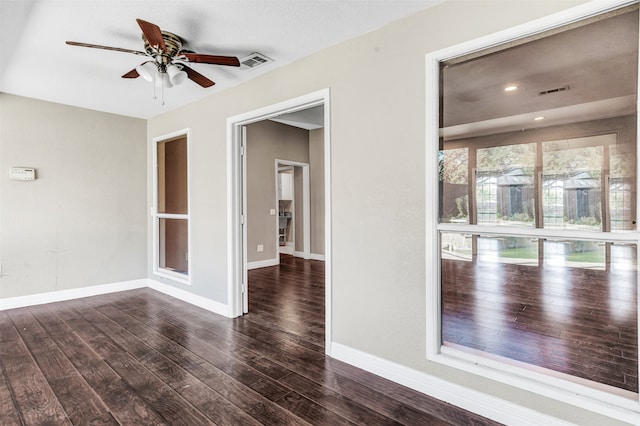 spare room with dark hardwood / wood-style floors and ceiling fan