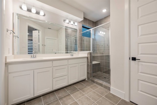 bathroom with vanity, tile patterned floors, and a shower with door