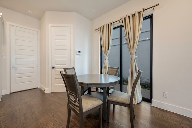 dining area with dark hardwood / wood-style floors