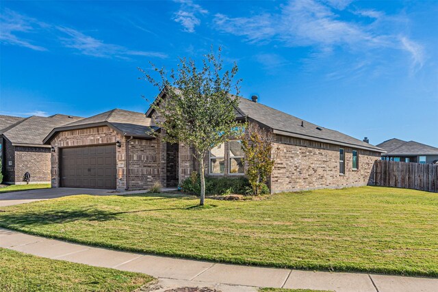 view of front of property featuring a garage and a front yard