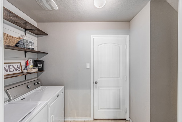 washroom featuring separate washer and dryer and a textured ceiling