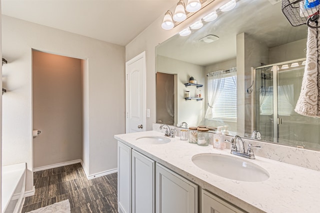 bathroom with plus walk in shower, vanity, and hardwood / wood-style floors