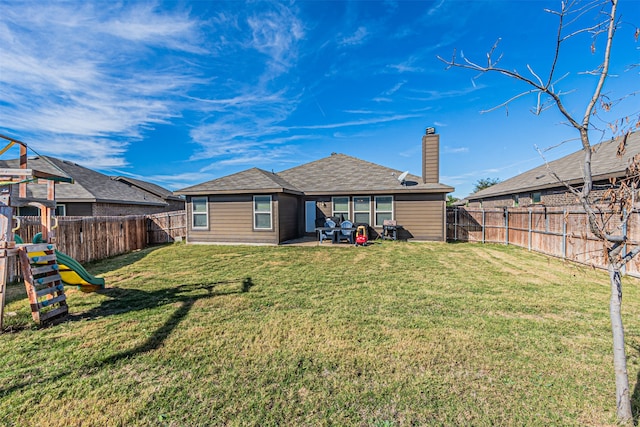 rear view of house featuring a patio area, a playground, and a yard