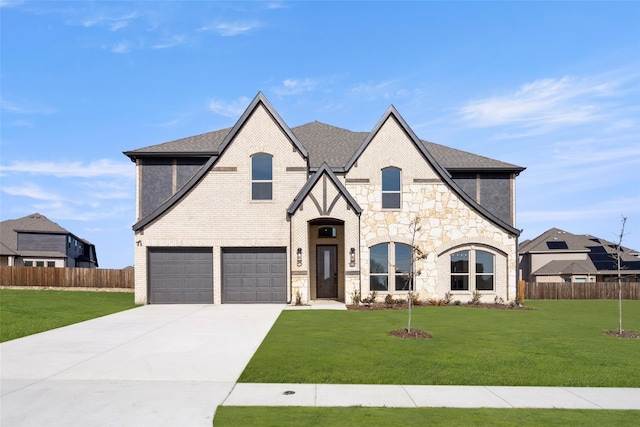 view of front of house with a garage and a front lawn