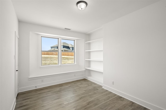 spare room with wood-type flooring