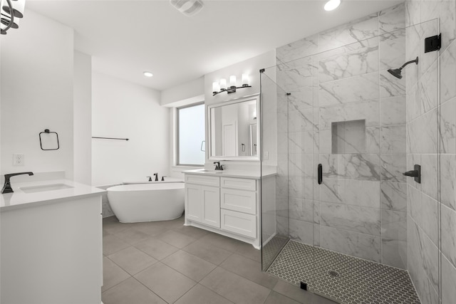 bathroom with tile patterned floors, vanity, and independent shower and bath