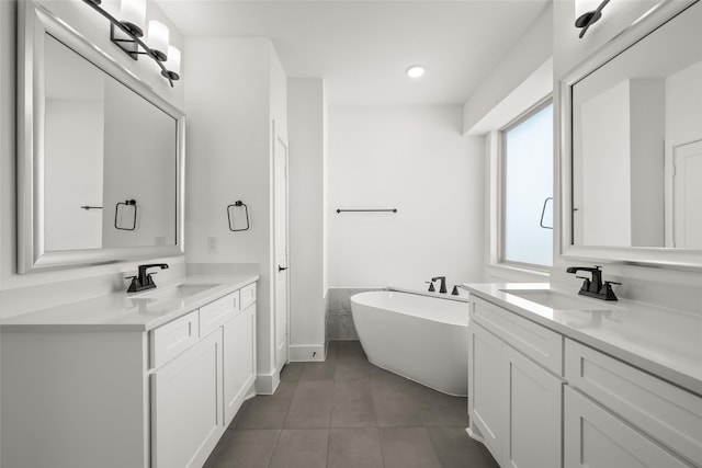 bathroom with vanity, tile patterned floors, and a bathing tub