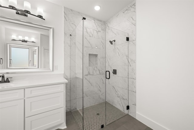 bathroom with a shower with door and vanity