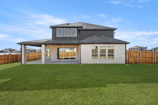 rear view of house featuring a patio and a lawn