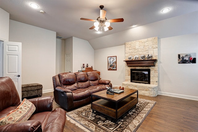 living room featuring a fireplace, dark wood-type flooring, ceiling fan, and lofted ceiling