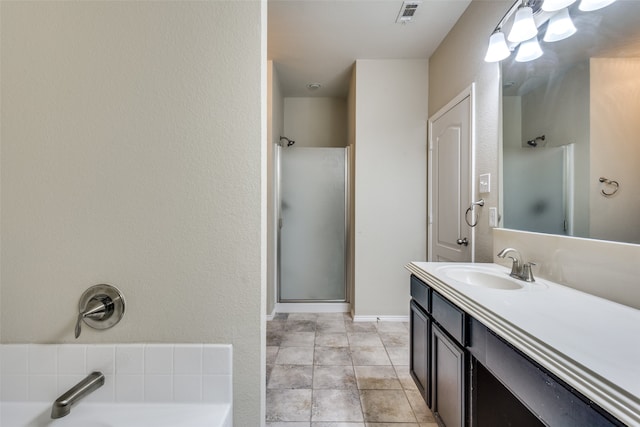 bathroom with vanity, tile patterned floors, and separate shower and tub