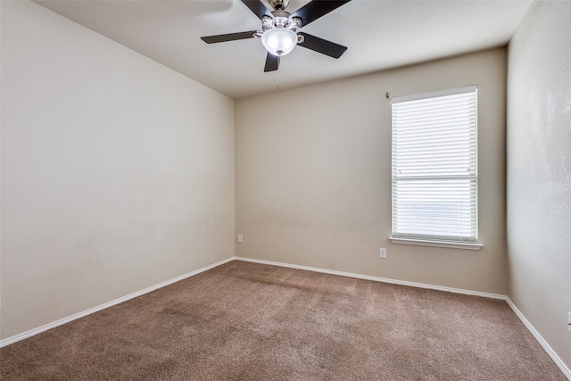 empty room with a wealth of natural light, ceiling fan, and carpet