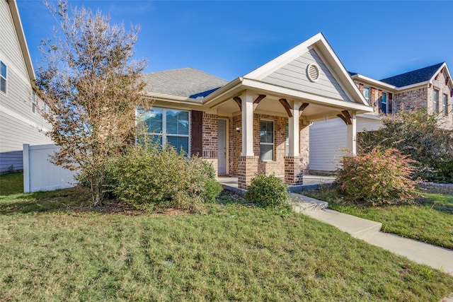 view of front of property featuring a front yard and a porch