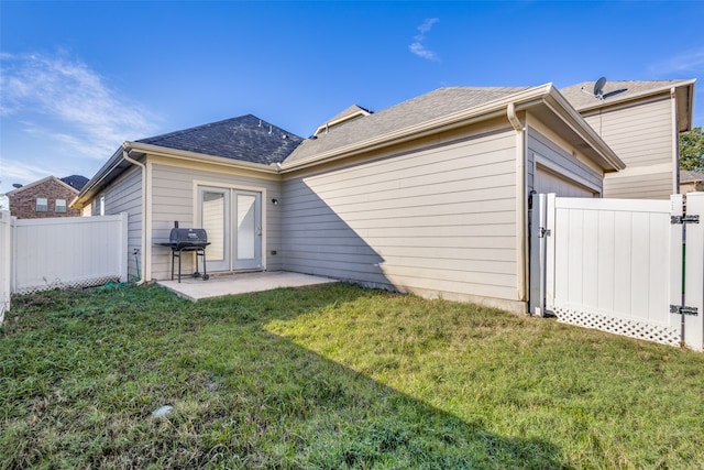 rear view of property featuring a patio and a yard