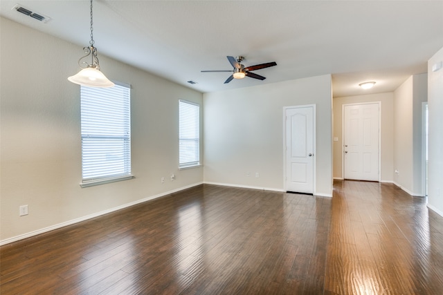 empty room with dark wood-type flooring and ceiling fan