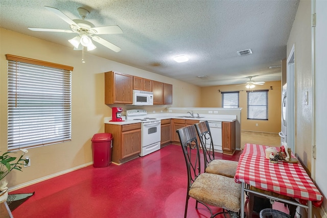 721 Grambling Dr, Dallas, TX 75241 - kitchen with white appliances, a ceiling fan, a peninsula, light countertops, and a textured ceiling