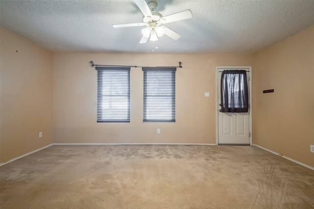 721 Grambling Dr, Dallas, TX 75241 - unfurnished room featuring carpet flooring, a textured ceiling, a ceiling fan, and baseboards