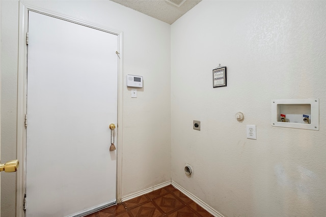 clothes washing area with a textured ceiling, electric dryer hookup, dark parquet floors, gas dryer hookup, and hookup for a washing machine