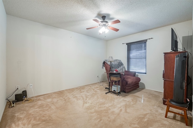 misc room featuring light colored carpet, a textured ceiling, and ceiling fan