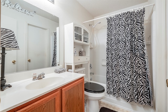 full bathroom with vanity, shower / bath combination with curtain, a textured ceiling, and toilet