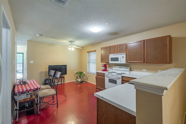 kitchen with kitchen peninsula, white appliances, a textured ceiling, and ceiling fan