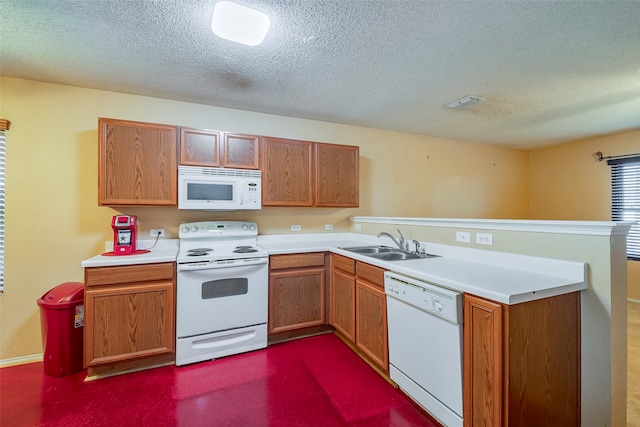 kitchen with a textured ceiling, kitchen peninsula, sink, and white appliances