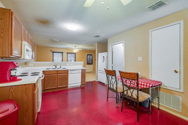 kitchen featuring white appliances, ceiling fan, a textured ceiling, and sink